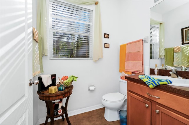 bathroom featuring tile patterned flooring, vanity, and toilet