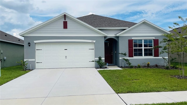 view of front of house with a garage and a front yard