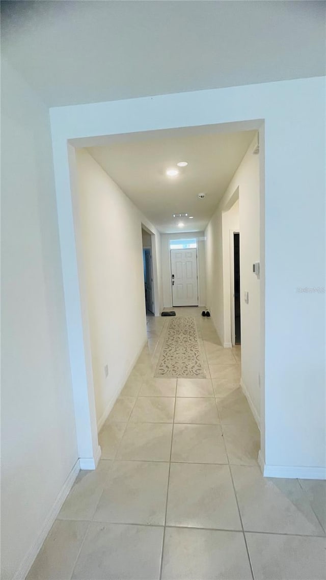 hallway featuring light tile patterned floors