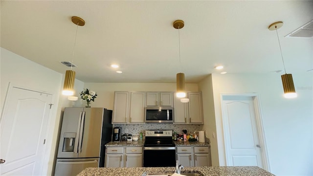 kitchen with gray cabinetry, hanging light fixtures, decorative backsplash, light stone countertops, and stainless steel appliances