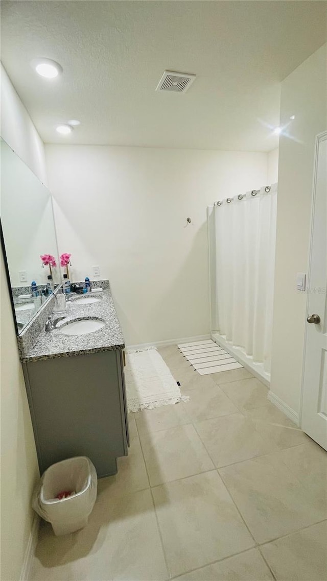 bathroom with vanity, tile patterned floors, and walk in shower