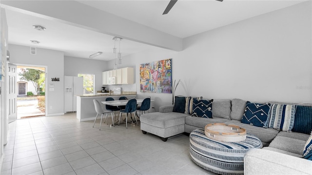 tiled living room with ceiling fan