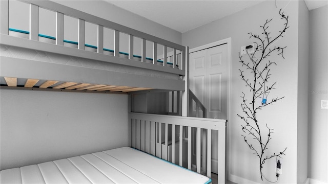 bedroom with a closet and a nursery area