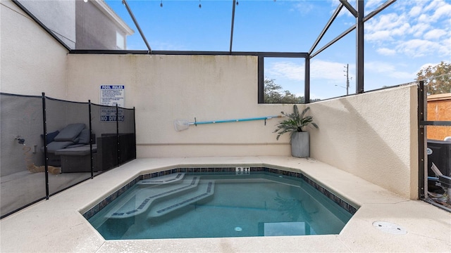 view of swimming pool featuring a lanai