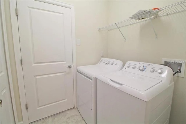 clothes washing area featuring washing machine and clothes dryer