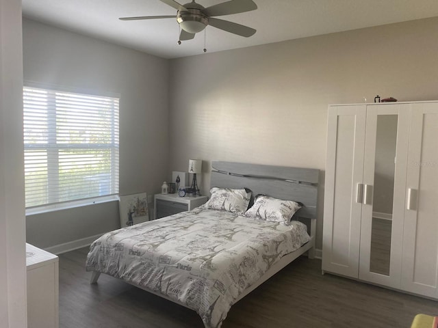 bedroom featuring dark hardwood / wood-style flooring and ceiling fan