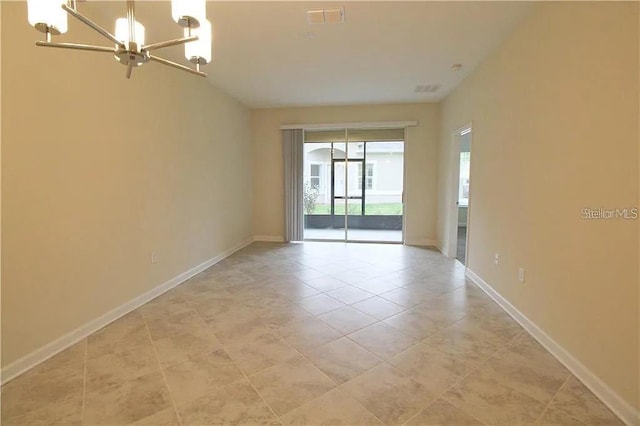 unfurnished room with a chandelier