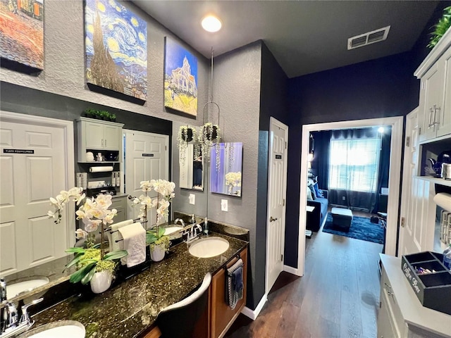 bathroom featuring wood-type flooring and sink