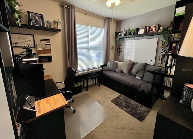 carpeted office space featuring ceiling fan