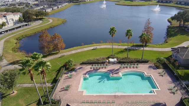 view of pool with a patio and a water view