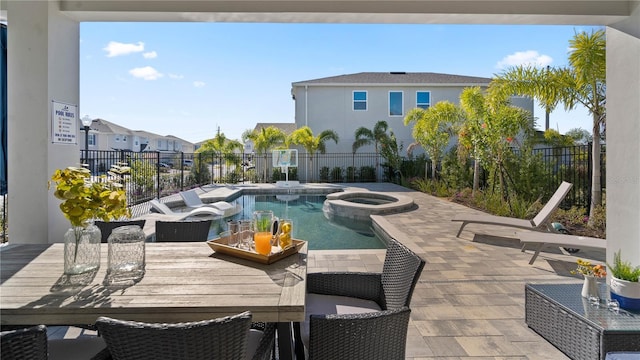 view of swimming pool with an in ground hot tub and a patio