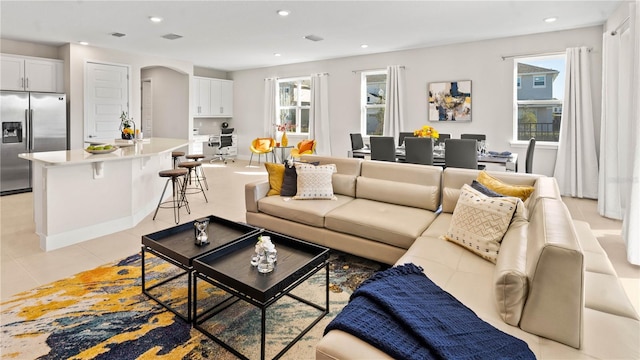 tiled living room featuring a wealth of natural light