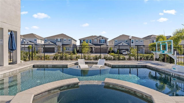 view of swimming pool featuring an in ground hot tub