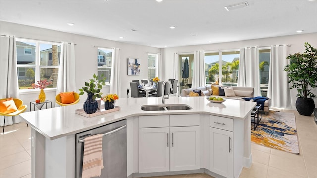 kitchen featuring a kitchen island with sink, white cabinetry, sink, and stainless steel dishwasher