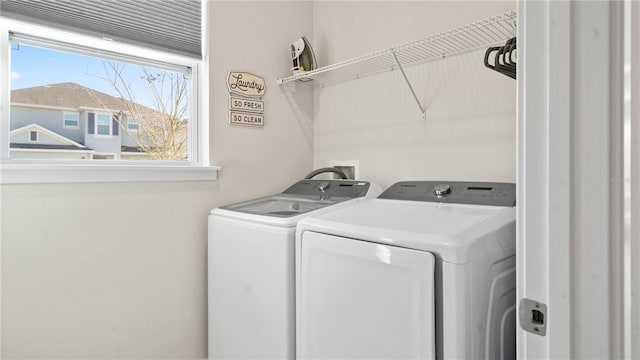 clothes washing area featuring washing machine and dryer