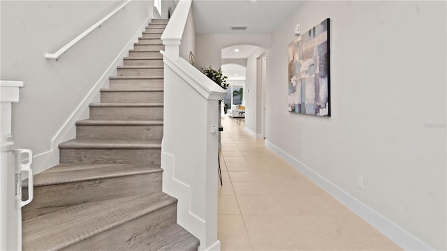 staircase with tile patterned floors