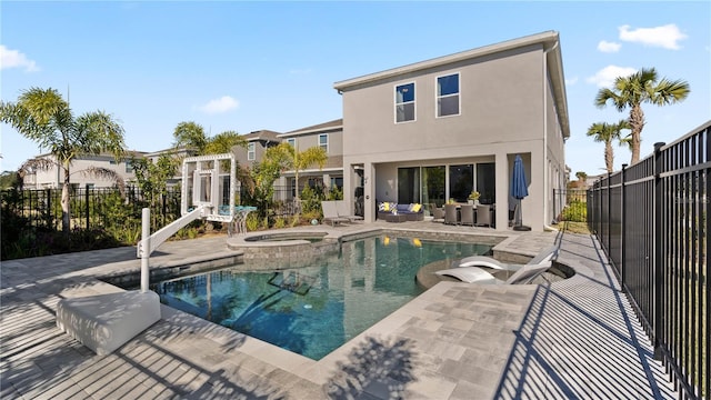 view of swimming pool with an in ground hot tub and a patio