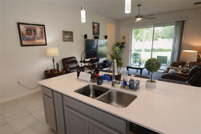 kitchen with sink, ceiling fan, gray cabinets, decorative light fixtures, and light tile patterned flooring