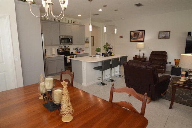 tiled dining space featuring an inviting chandelier