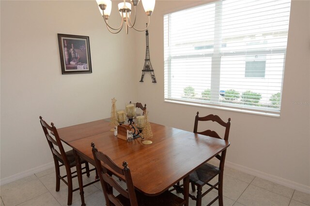 tiled dining room featuring a notable chandelier