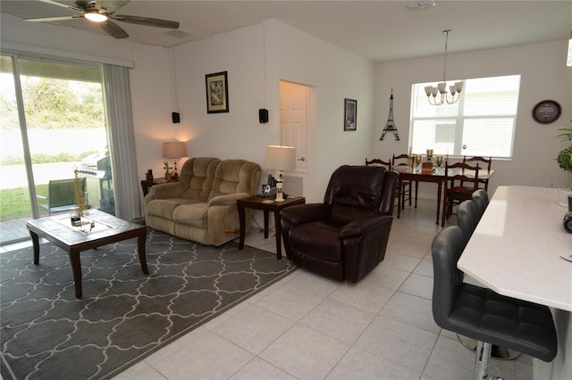 tiled living room featuring ceiling fan with notable chandelier