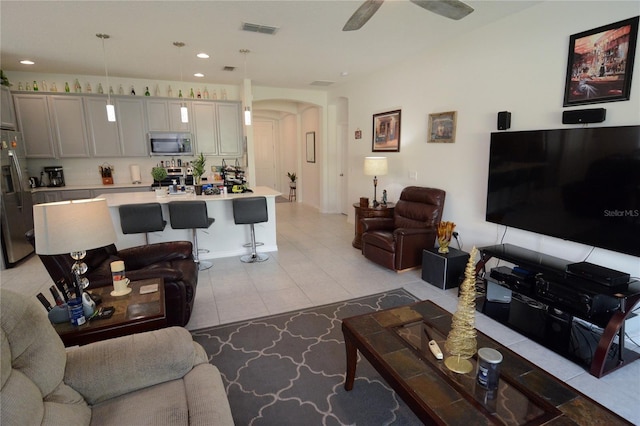 living room featuring ceiling fan and light tile patterned flooring