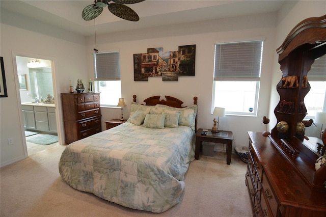 bedroom with light colored carpet, multiple windows, and ceiling fan