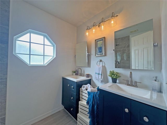 bathroom featuring a shower, wood-type flooring, and vanity