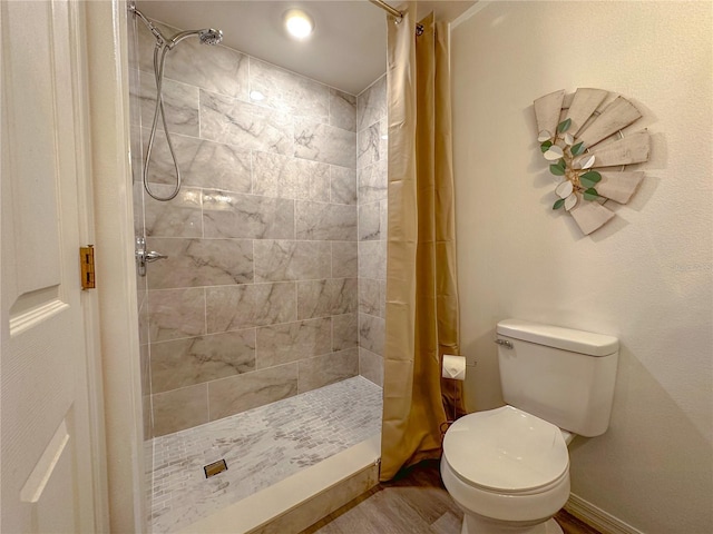 bathroom featuring toilet, wood-type flooring, and a shower with shower curtain