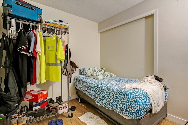 bedroom with hardwood / wood-style floors and a textured ceiling