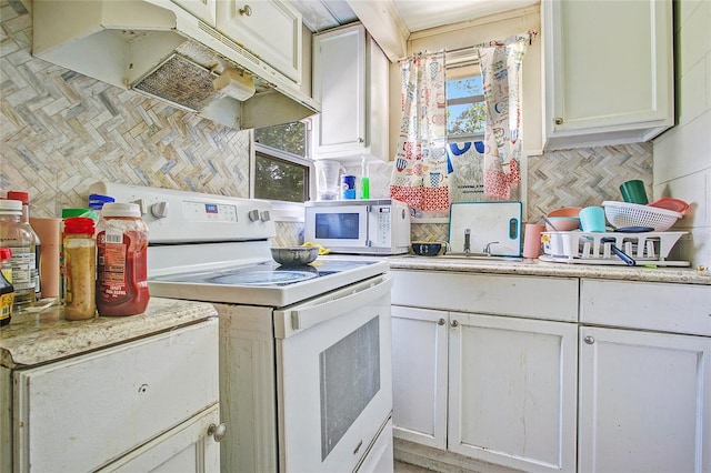 kitchen with backsplash, white cabinetry, plenty of natural light, and white appliances