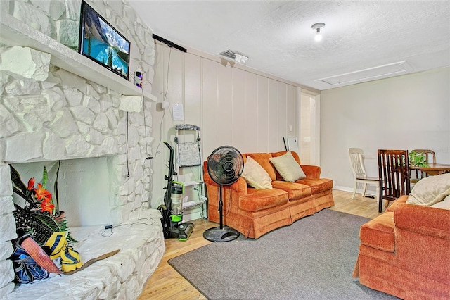 living room featuring a textured ceiling and light wood-type flooring