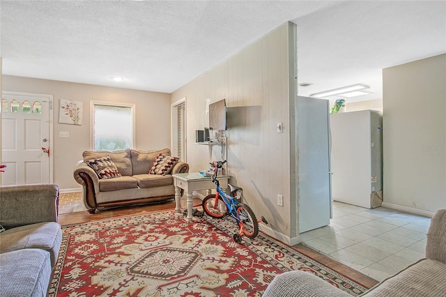 living room featuring light tile patterned floors and a textured ceiling