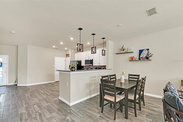 dining space featuring light hardwood / wood-style floors