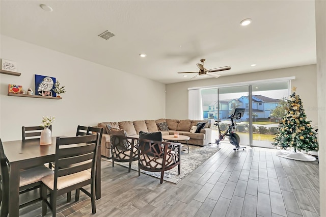 living room featuring hardwood / wood-style flooring and ceiling fan