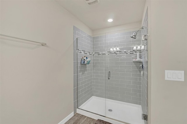 bathroom featuring hardwood / wood-style floors and walk in shower