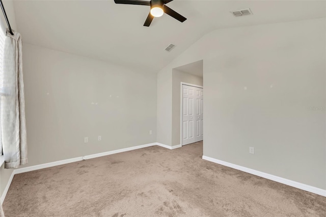 carpeted empty room featuring lofted ceiling and ceiling fan