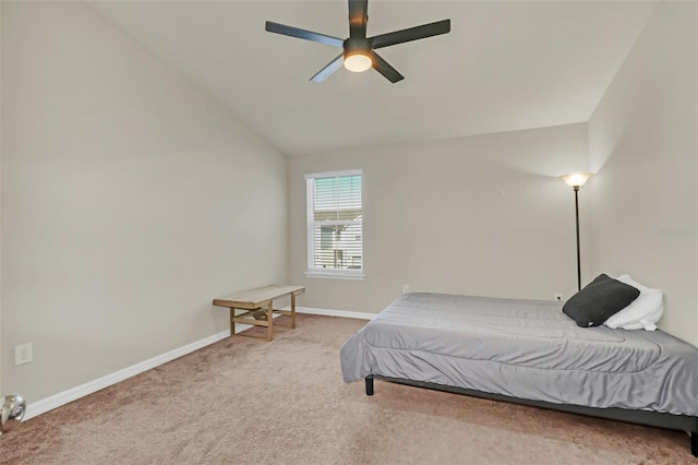 carpeted bedroom with vaulted ceiling and ceiling fan