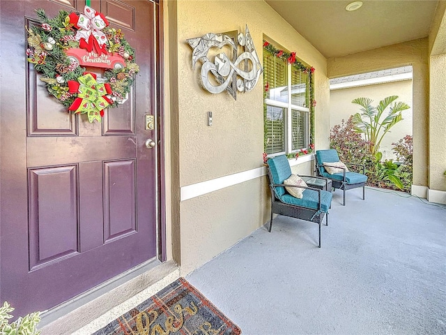 view of exterior entry featuring a porch