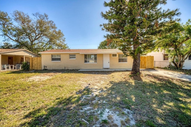 ranch-style home with a front lawn