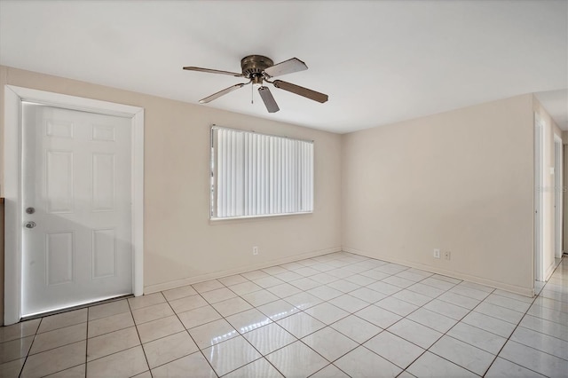 empty room featuring ceiling fan and light tile patterned flooring