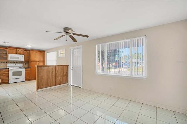 kitchen with decorative backsplash, ceiling fan, light tile patterned flooring, and white appliances