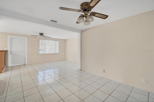 tiled empty room featuring ceiling fan