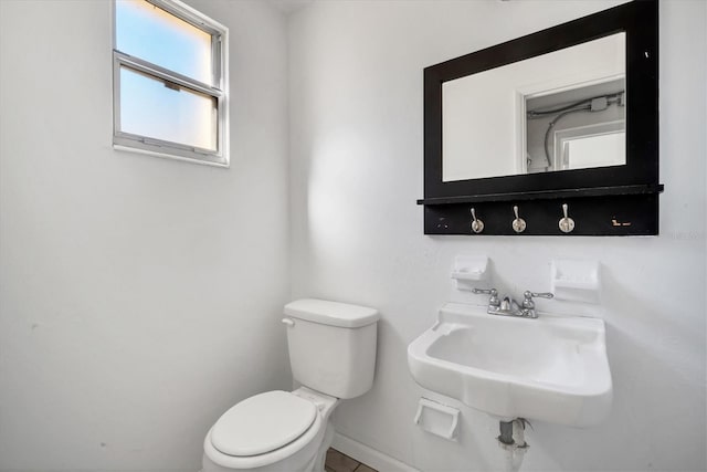 bathroom featuring toilet and sink