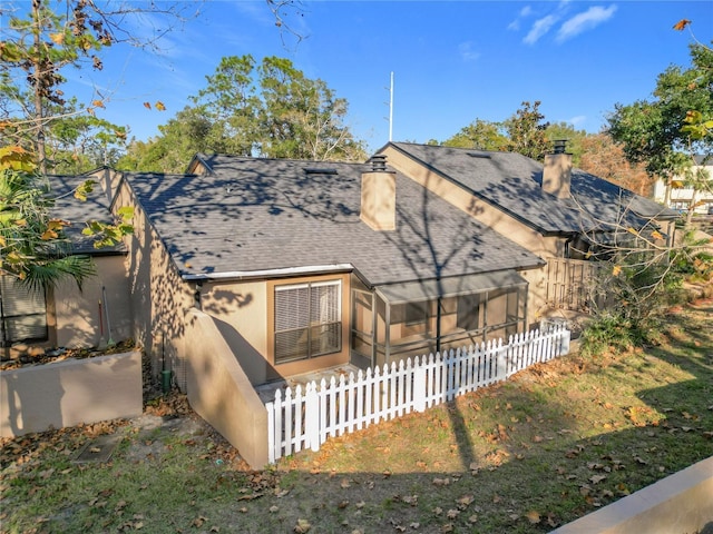 rear view of property with a sunroom