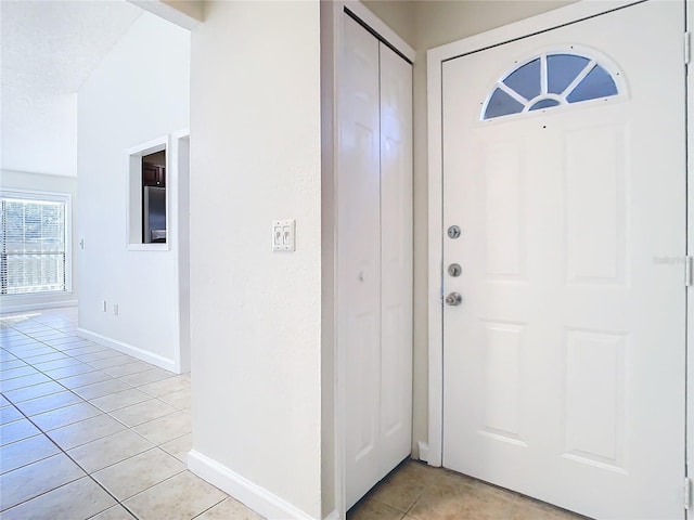 foyer featuring light tile patterned floors