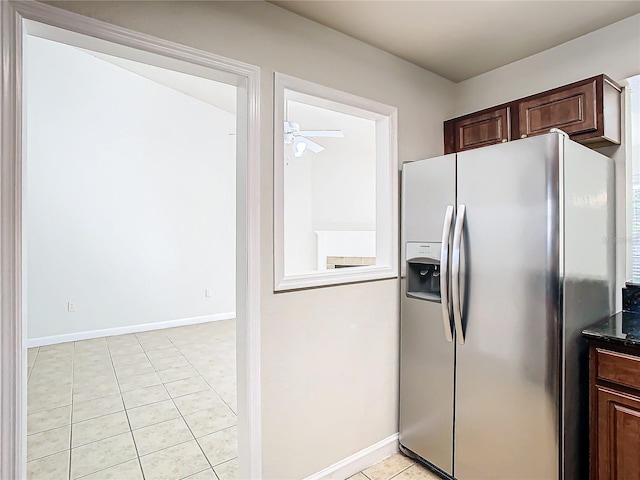 kitchen with stainless steel fridge with ice dispenser, dark brown cabinets, light tile patterned floors, and ceiling fan