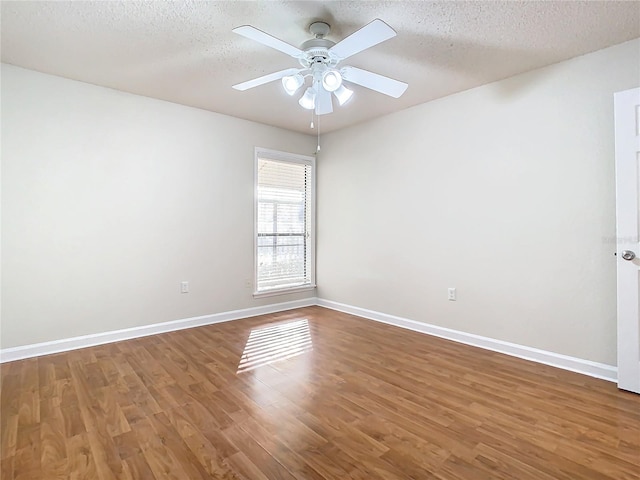 spare room featuring hardwood / wood-style flooring, ceiling fan, and a textured ceiling