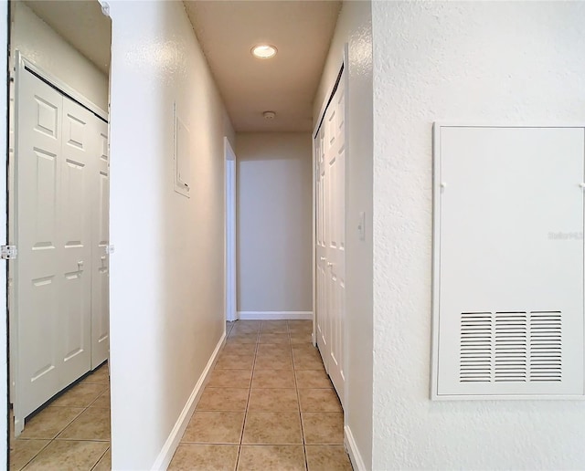 hall featuring light tile patterned floors