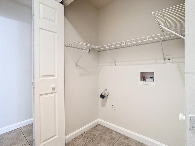 laundry room featuring light tile patterned floors and hookup for a washing machine